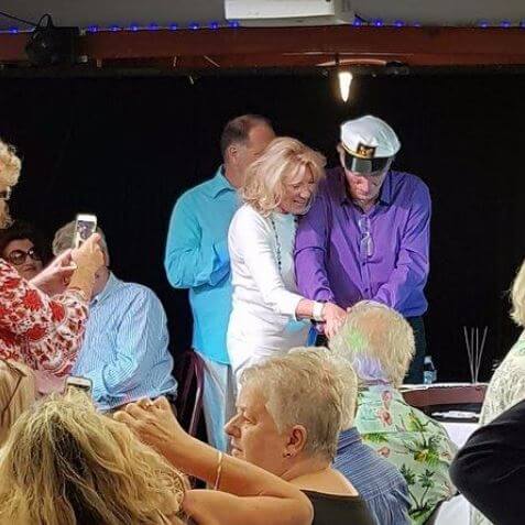 Carole Wood with her husband, Frank Ifield, cutting the cake in their 25th wedding ceremony.